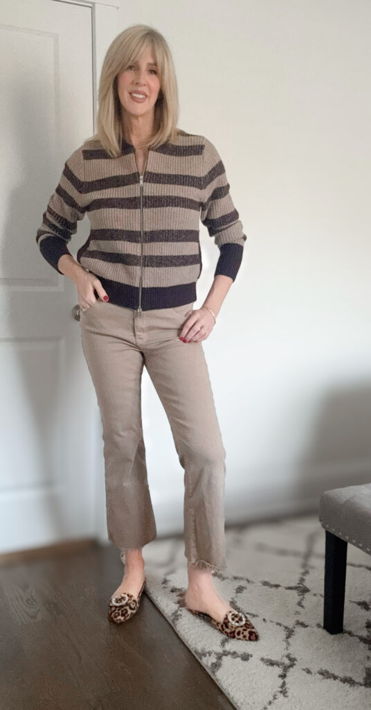 woman wearing a neutral outfit with tan denim, a tan and brown striped cardigan and a fun leopard flat demonstrating classic style with a pop of personality